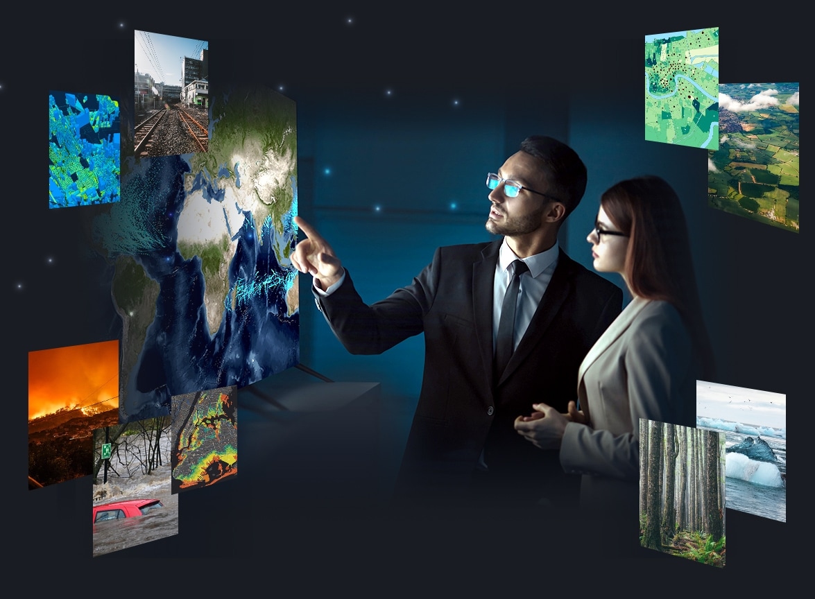 Two business professionals looking at a series of images including a wildfire, a car in a flood, a railroad, and a forest